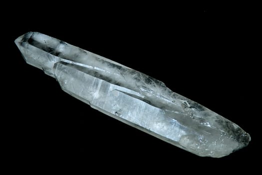 A quartz crystal wand shot over black.