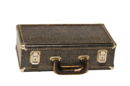 A small antique hard case with locks and handle shot over white.