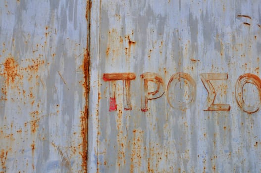 Rusty metal surface with hand painted typography. Abstract grunge background.