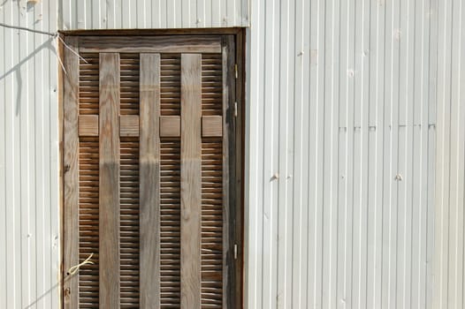 Plastic trailer wall and wooden door exterior abstract background.