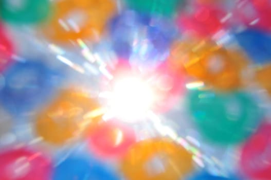 Sunrays and color circles abstract blur. Painted glass lens flare reflections.