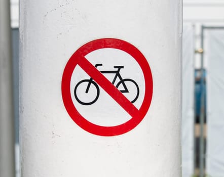 sticker with bicycle ban on a pole