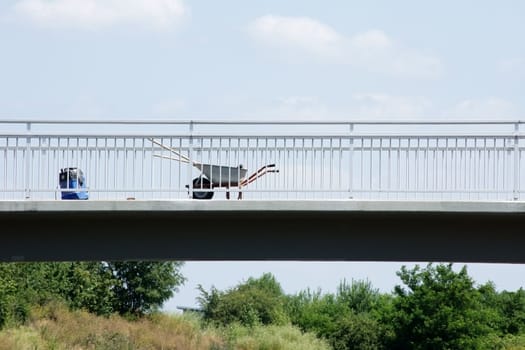 Photograph of a construction site with cleaning utensils on a bridge.