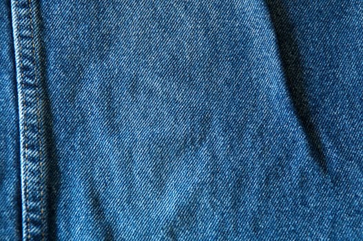 Close up of blue denim showing double seam.