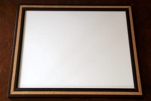 A blank white board surrounded with cork.
