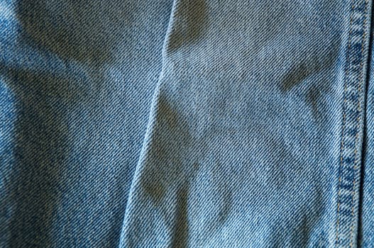 Close up of blue denim showing double seam.