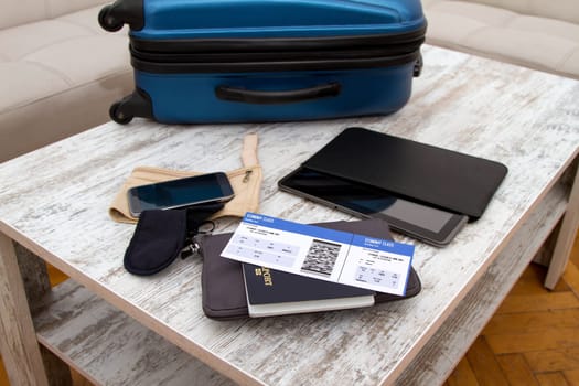 Airline ticket, passport and luggage, ready to travel.
