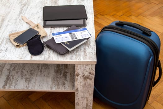 Airline ticket, passport and luggage, ready to travel.