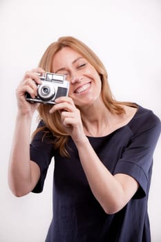 smiling real woman taking shootings with her camera