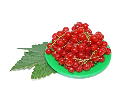 Red currant on small plates decorated with leaves isolated