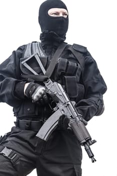 Spec ops soldier in black uniform and face mask with his rifle