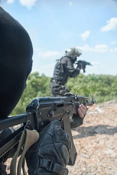 Two spec ops soldiers in black uniform in action