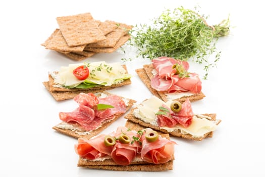 Finnish rye crispbread with salami Milano,Coppa ham,Prosciutto Crudo,Emmentaler,cream cheese with Herbs of Provence and Olive
