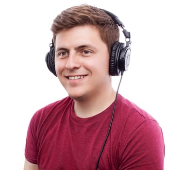 Young happy man listening something on headphones