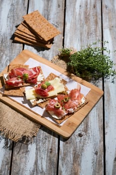 Finnish rye crispbread with salami Milano,Coppa ham,Prosciutto Crudo,Emmentaler,cream cheese with Herbs of Provence and Olive