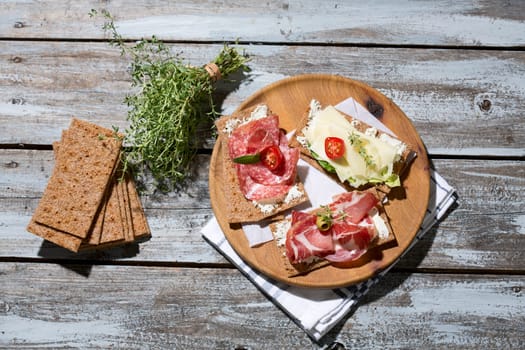 Finnish rye crispbread with salami Milano,Coppa ham,Prosciutto Crudo,Emmentaler,cream cheese with Herbs of Provence and Olive