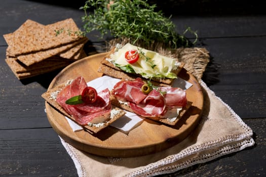 Finnish rye crispbread with salami Milano,Coppa ham,Prosciutto Crudo,Emmentaler,cream cheese with Herbs of Provence and Olive