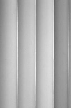 Image shows four slats of a vertical blind in black and white.