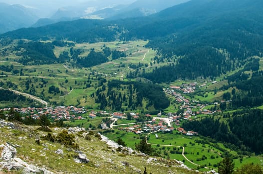 Elevational view of forest mountain village in sunny day