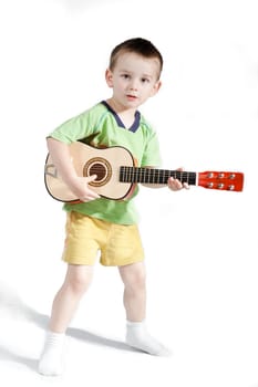 Child playing on guitar isolated on a white background