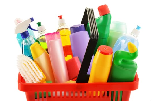 Shopping basket with detergent bottles and chemical cleaning supplies isolated on white