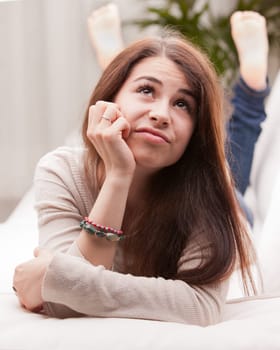 girl wondering something that could happen on a sofa or somewhere else in her life or in the world