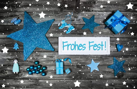 Merry christmas greetings in german language. Decoration in rustic blue country style on wooden background.