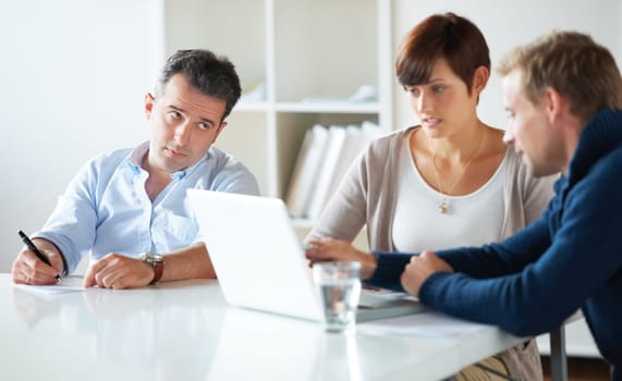 Team, laptop and discussion in business meeting, collaboration and online research for agenda. Business people, teamwork and conversation or communication for proposal, consulting and talking on work.