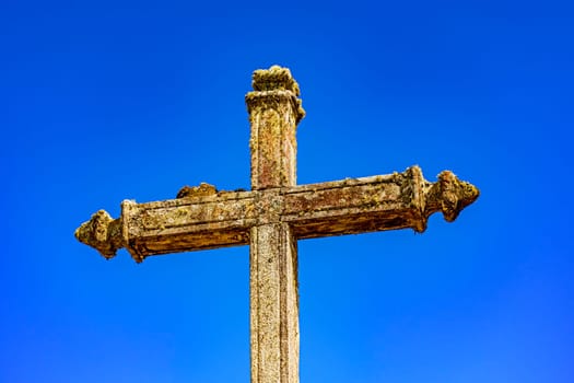 Old baroque crucifix deteriorated by time in Lavras Novas, Minas Gerais