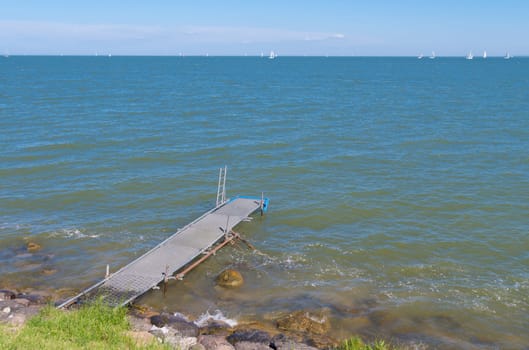 old decayed pier at the Markermeer in the netherlands