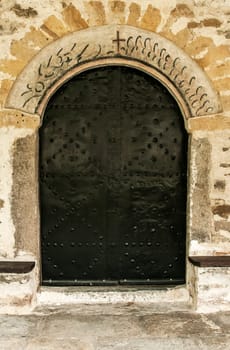 Old metal orthodox church side black door