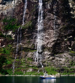 Geiranger Fjord in Norway with waterfall and boat