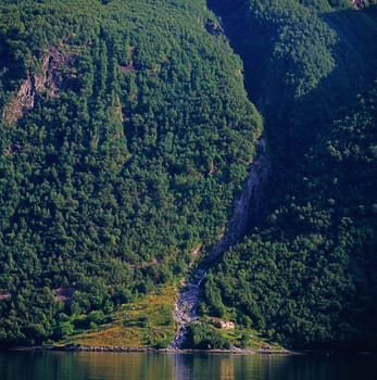Geiranger Fjord in Norway with waterfall and  house