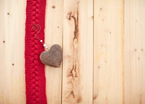 Background in rustic wood with knitted braid pattern in red