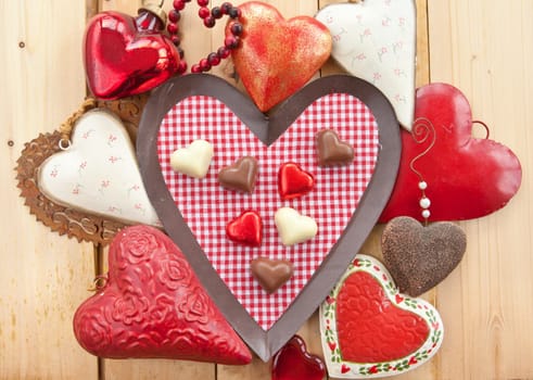 Various chocolates in heart shape on a checkered background