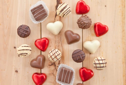 Various chocolates and trueffel on rustic background made of wood