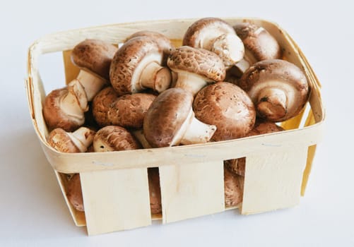 raw mushrooms (champignons) on a white table