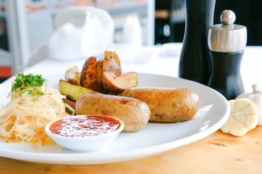 Italian Sausage with wegetables on dish and ketchup