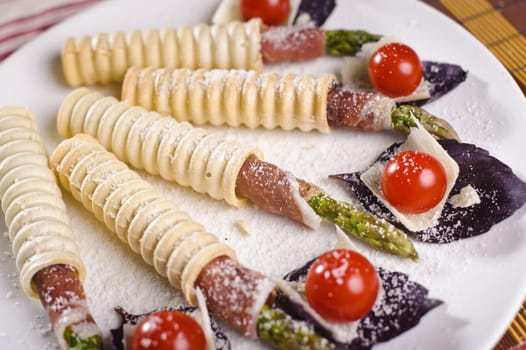 Few snaks on a plate with vegetables and bacon