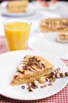 Piece of cake with chokolate and juice on white plate