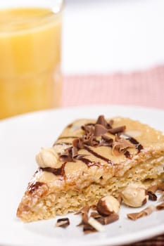 Piece of cake with chokolate and juice on white plate