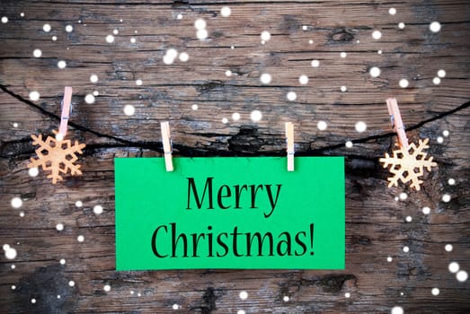 Green Label with the words Merry Christmas on it, Label in the Snow