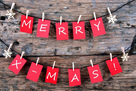 Red Tags Hanging on a Line with the Words Merry X-Mas on it, Christmas Background