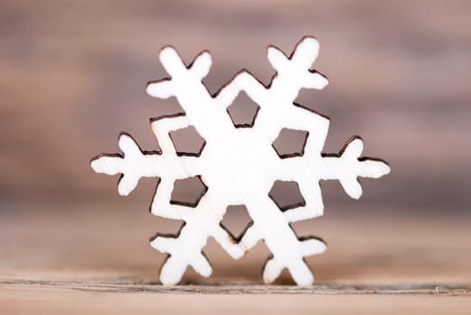 A Single Light Snowflake on Wood, Macro