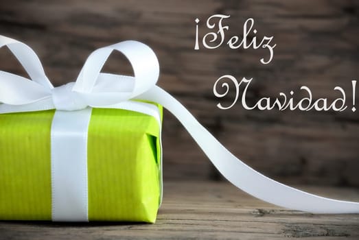 Green Present with the Spanish Words Feliz Navidad, which means Merry Christmas, on Wooden Background