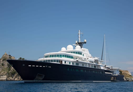 Gigantic big and large luxury yacht with sail boat and helicopter landing place on bord. Investment concept for millionaires.