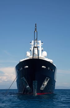 Gigantic big and large luxury mega yacht with helicopter landing place on the blue ocean. Investment for millionaires.