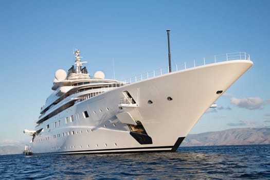 Gigantic big and large luxury mega or super motor yacht on the blue ocean.