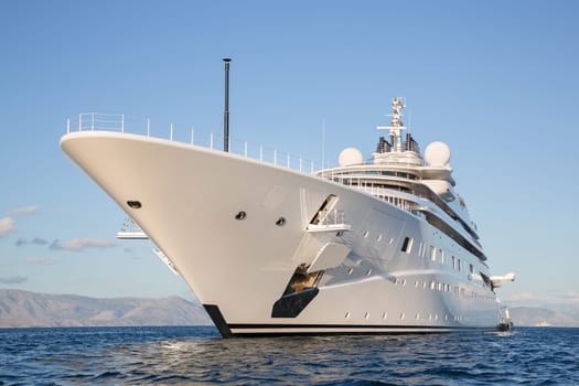 Gigantic big and large luxury mega or super motor yacht on the blue ocean.