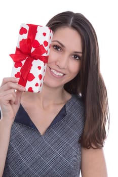 Isolated smiling pretty woman holding a present with red hearts in her hands.